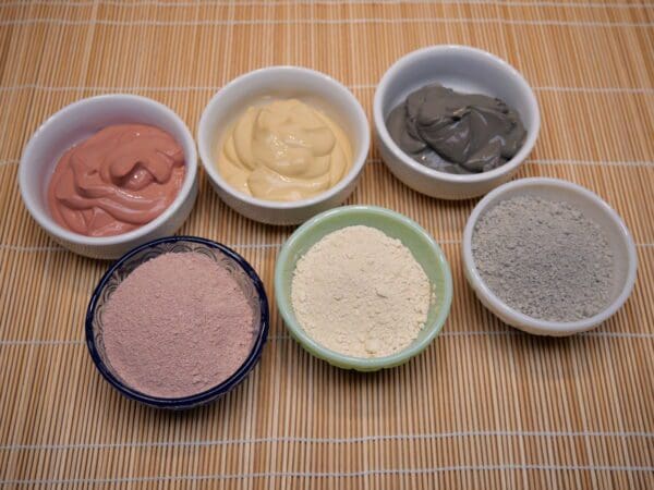 A group of bowls filled with different types of food.