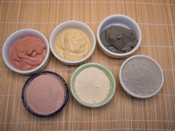 A group of bowls filled with different types of food.