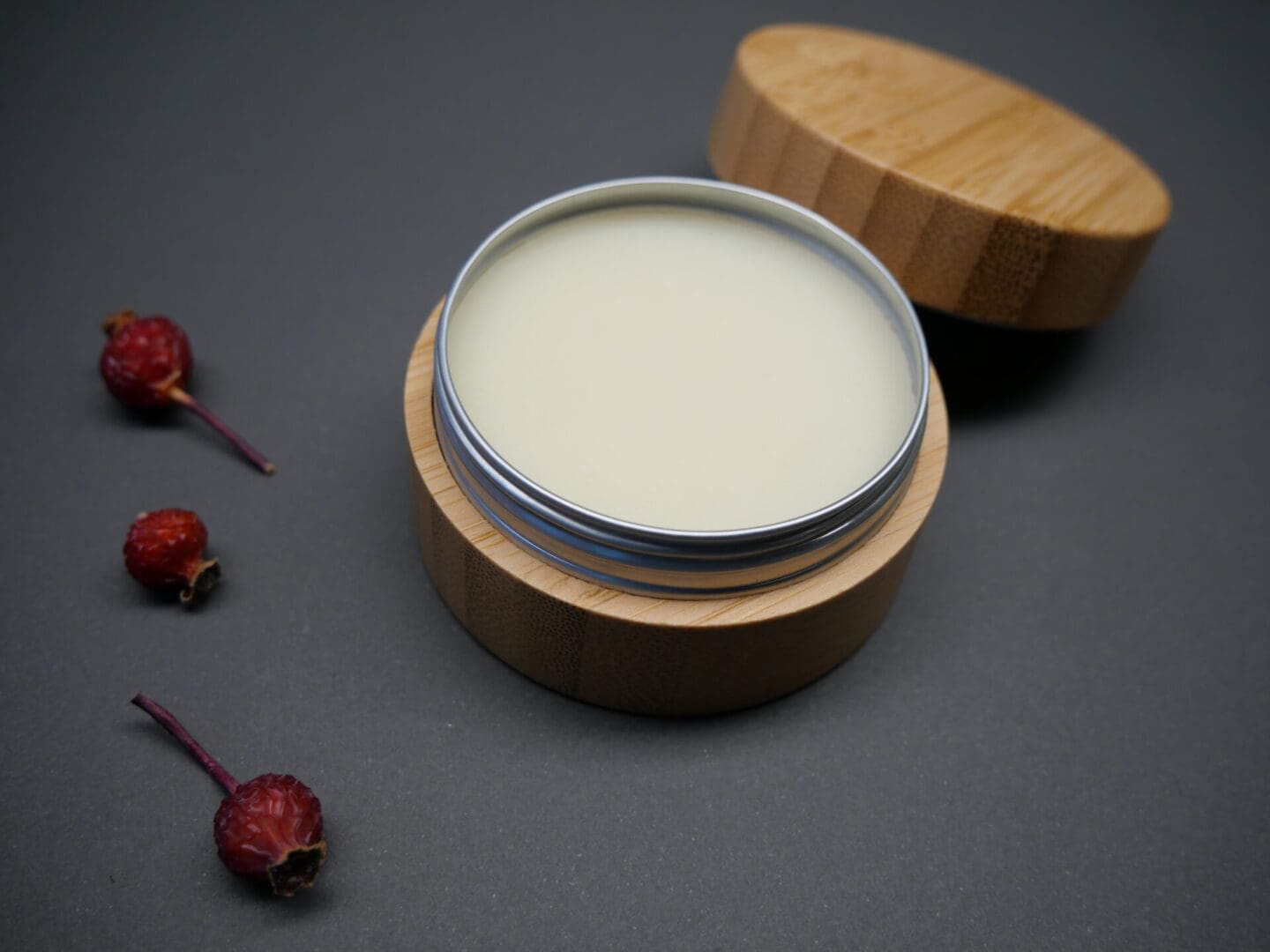 A natural wooden tin containing a soothing BreuRx Massage & Foot Butter Balm.