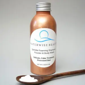 A bottle of hair color and a wooden spoon