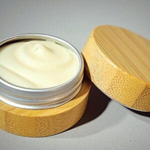 A wooden container with a cream on it.