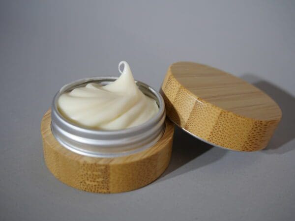 A wooden container with a cream on top of it.