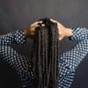 A person with their hands on her head