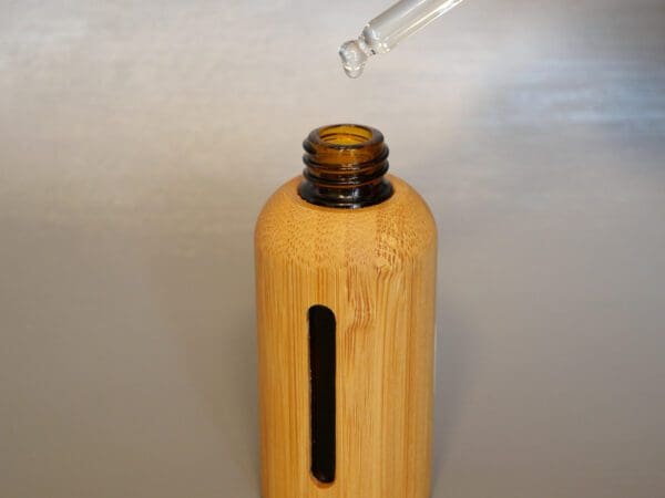 A bamboo bottle with a straw in it.