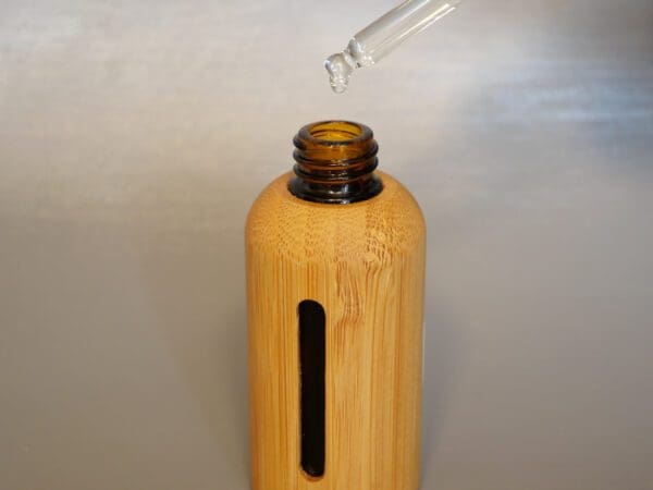 A bamboo bottle with a straw in it.