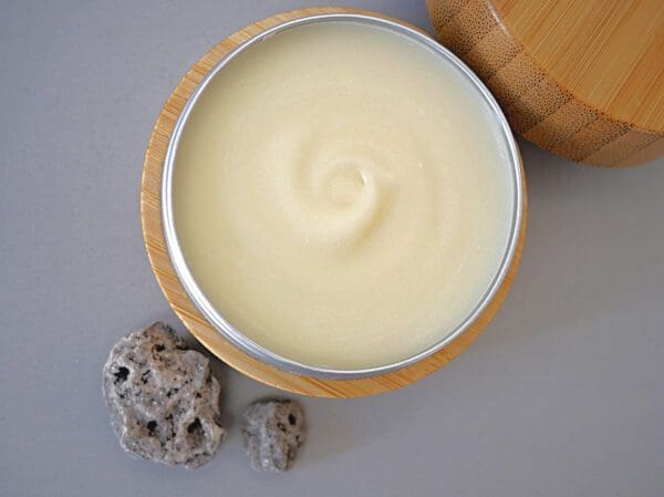 A bowl of cream next to two rocks.