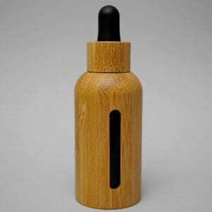 A wooden bottle with black cap and black strip.