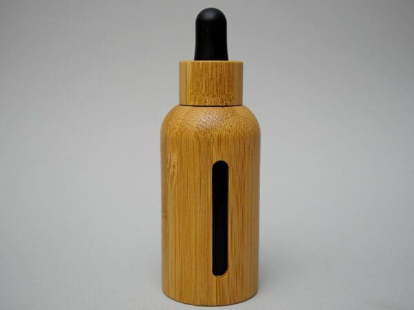 A wooden bottle with black cap and black strip.