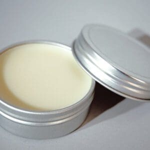 A tin of cream sits on the table.