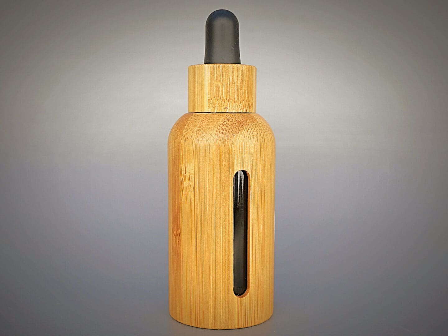 A wooden bottle with a black lid.