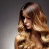A woman with long hair is looking at the camera.